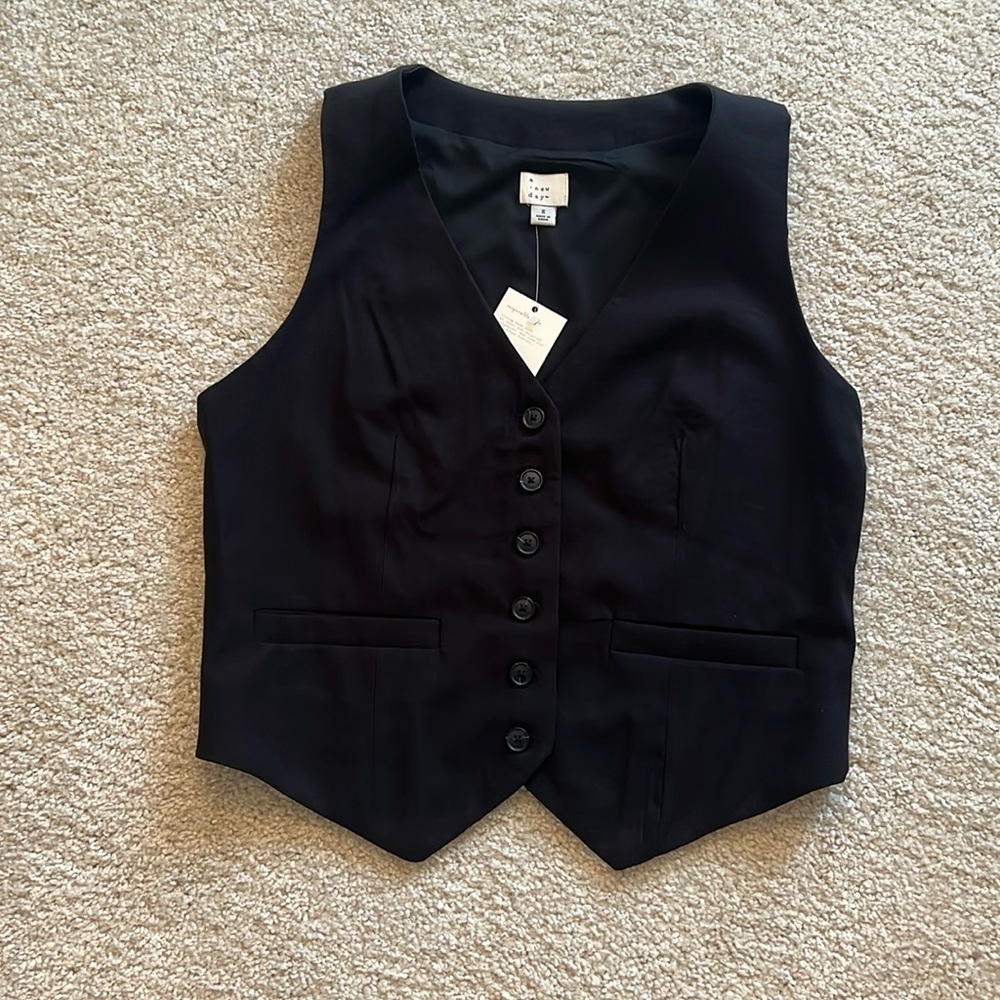 Black button up vest with buttons and pocket details. Size Small.